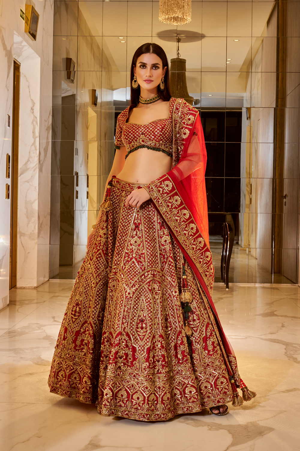 DEEP RED TRADITIONAL BRIDAL LEHENGA SET WITH GOLD EMBROIDERY PAIRED WITH A  MATCHING DUPATTA, JADE GREEN TASSELS AND ALL OVER GOLD EMBELLISHMENTS -  Seasons India