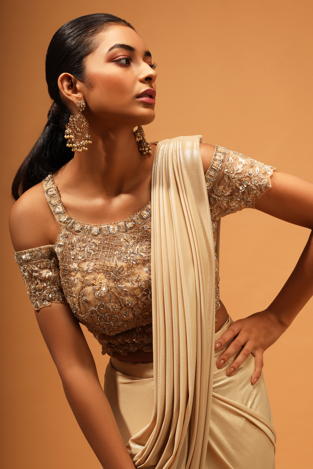 BEIGE GOLD PRE STITCHED DRAPED SAREE WITH A HAND EMBROIDERED COLD SHOULDER  BLOUSE AND SILVER EMBELLISHMENTS. - Seasons India